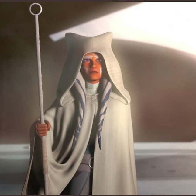 Ahsoka stands wearing all white and leaning on a staff in a scene from Star Wars: Rebels.
